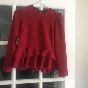 Red long sleeved blouse w/button cuffed sleeves, 2ruffles @ bottom,sits at waist